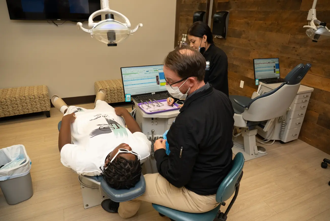 A clinician providing dental care to a patient